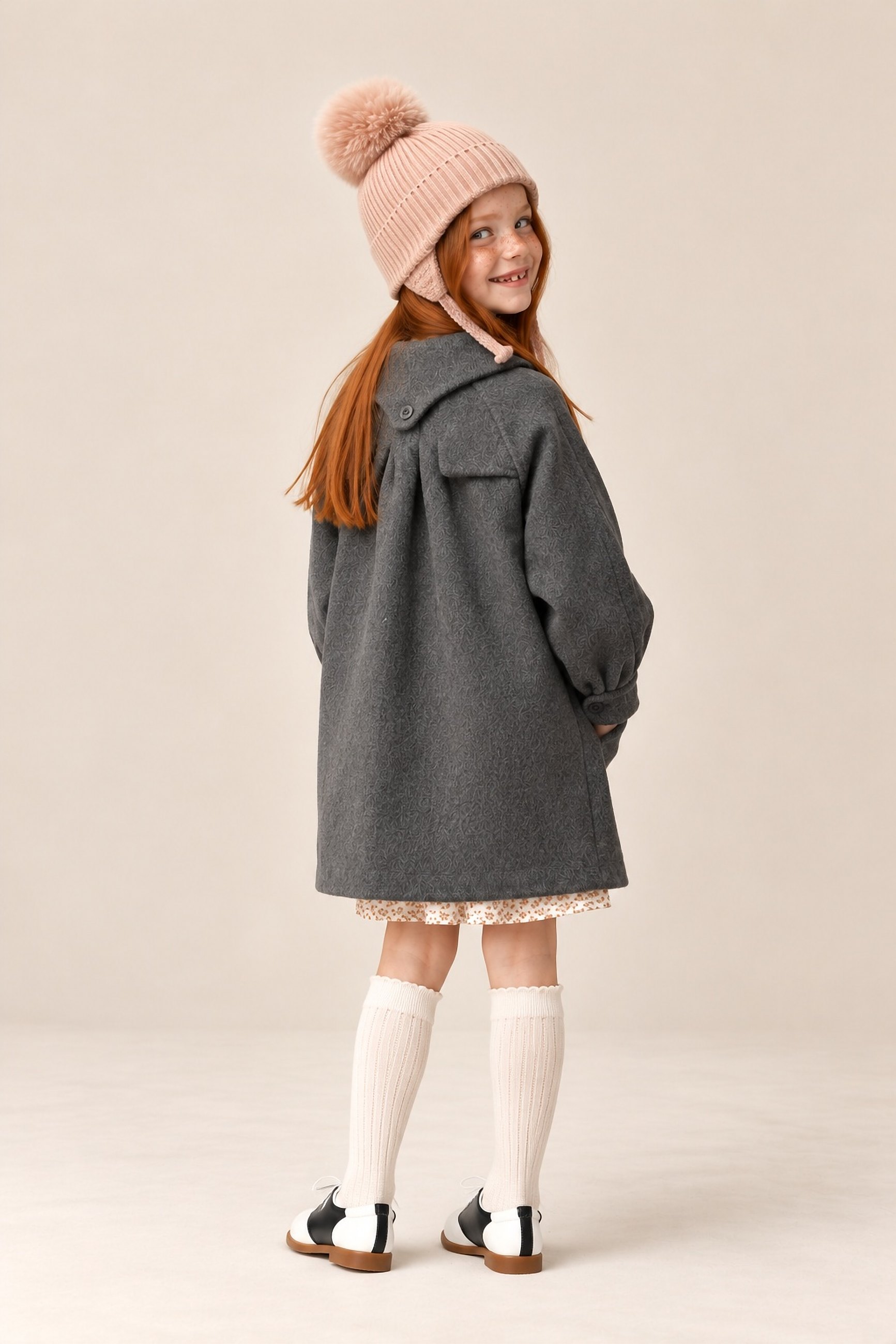 The slate wool coat from behind, a girl glancing over her shoulder