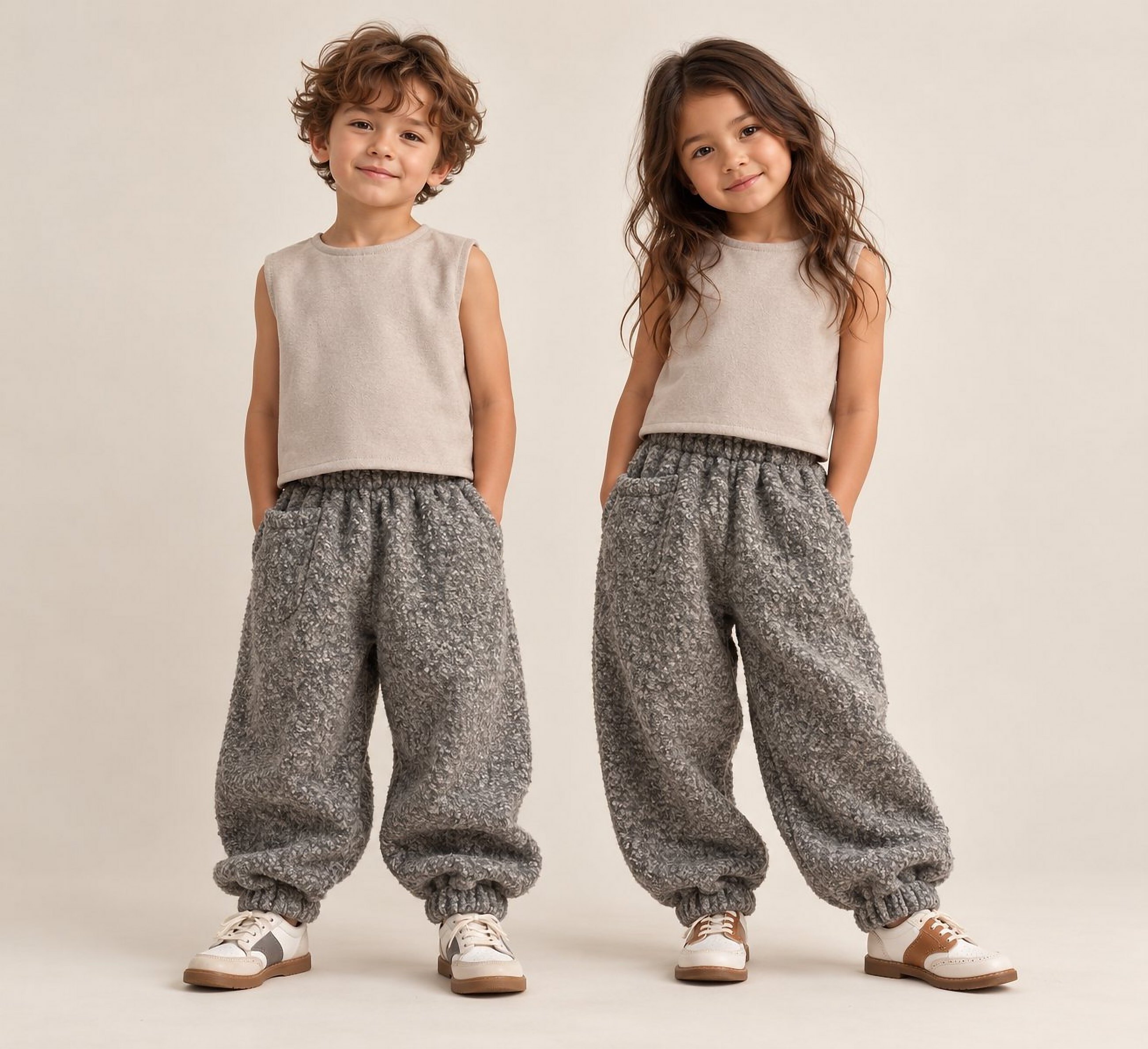 A girl and a boy in the knit vest and boucle jogger set