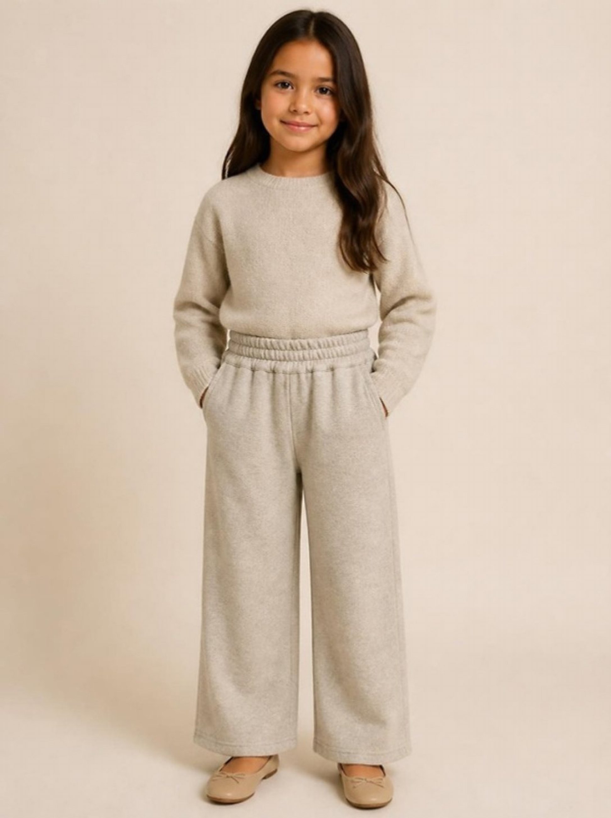 A girl in the cream wool wide-leg trousers and knit top